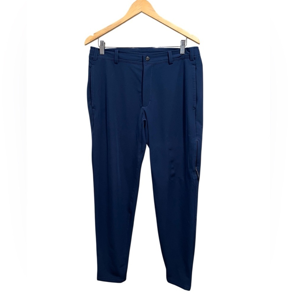 This is a pair of Mack Weldon men's pants in a navy blue color and size medium.